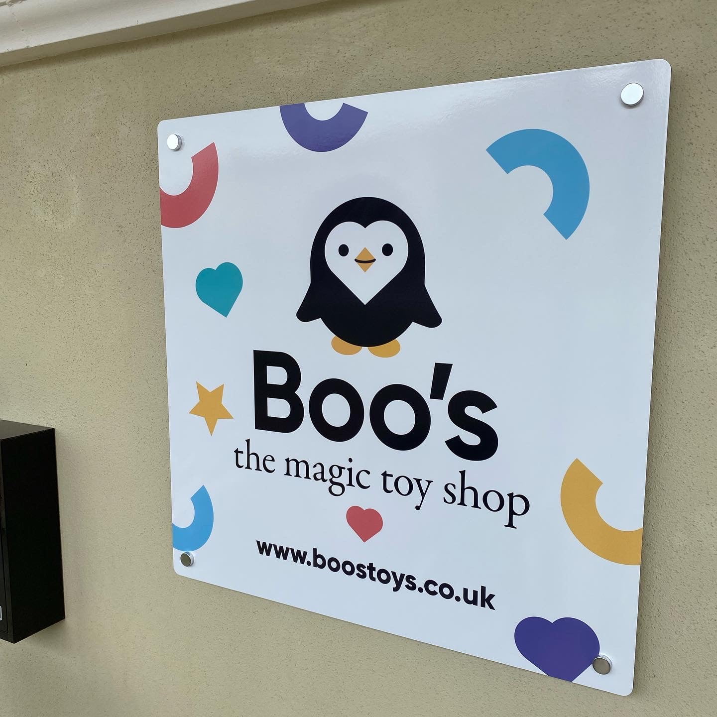 designed sign for boo's toy shop